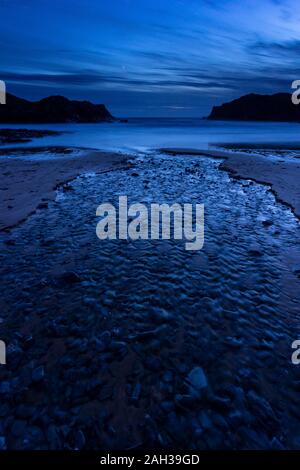 Dusk over the beach at Porth Dafarch on the Anglesey coast, North Wales Stock Photo
