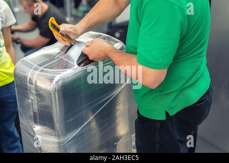 Luggage wrapping service at the airport terminal for security reason ...