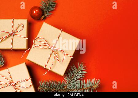 Gift boxes, candy canes and cypress branches. Christmas preparation of  gifts on red and beige wrapping paper. New Year concept. Top view, flat lay  Stock Photo - Alamy
