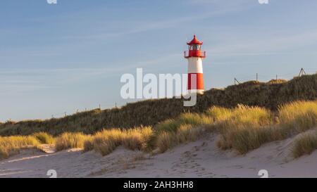 Portrait of lighthouse List West at Sylt Island with marram grass in the foreground Stock Photo