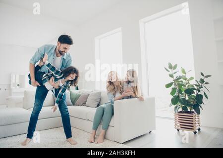 Photo of four people foster family moving like airplane with help parents hands cozy apartments indoors Stock Photo