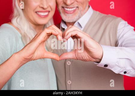 Cropped close up photo beautiful she her he him his aged guy lady partners couple making heart figure fingers romance date anniversary wear sweater Stock Photo