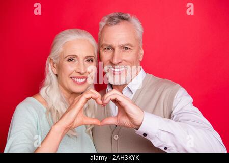 Close up photo beautiful cute she her he him his aged guy lady partners couple making heart figure fingers romance date anniversary wear sweater shirt Stock Photo