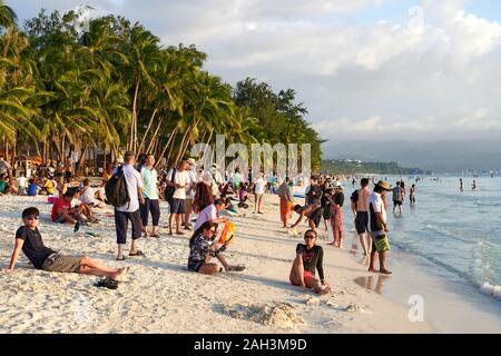 Boracay, Aklan Province, Philippines - January 13, 2019: Chinese tourists and filipino local residents hanging out at the White Beach for the sunset Stock Photo
