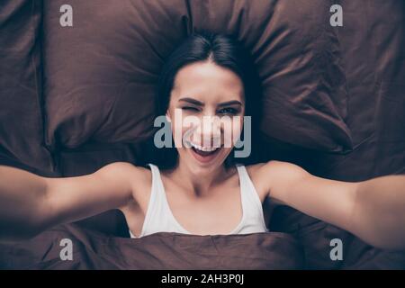 Self-portrait of her she nice-looking attractive lovable winsome lovely cute cheerful cheery glad girl covered marsala veil lying in bed winking room Stock Photo