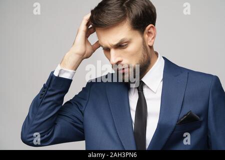 Studuo shot of thinking businessman wearing suit Stock Photo