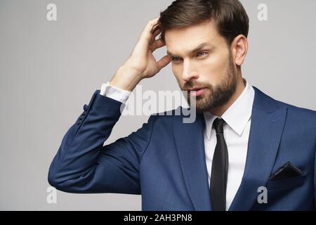 Studuo shot of thinking businessman wearing suit Stock Photo