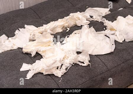 Mess of white tissue papers on sofa at living room Stock Photo