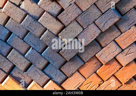 Pile of stacked new red bricks. Clay brick blocks ready for construction. Stock Photo