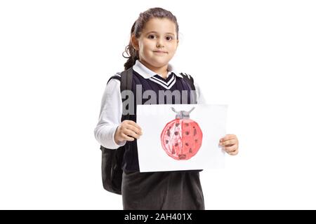 Schoolgirl holding a drawing of a ladybird isolated on white background Stock Photo