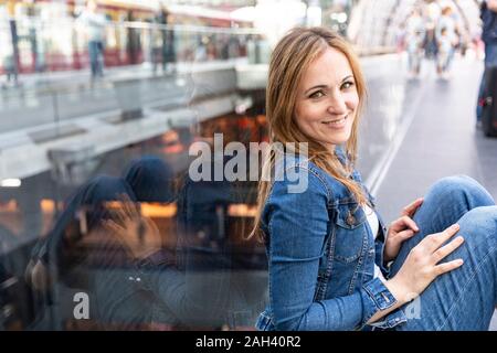 Portrait of smiling woman waiting at the train station, Berlin, Germany Stock Photo