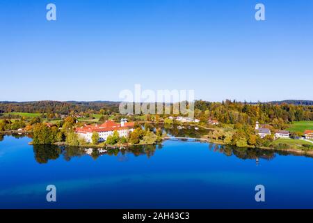 Germany, Bavaria, Seeon-Seebruck, Clear sky over Klostersee lake and Seeon Abbey Stock Photo