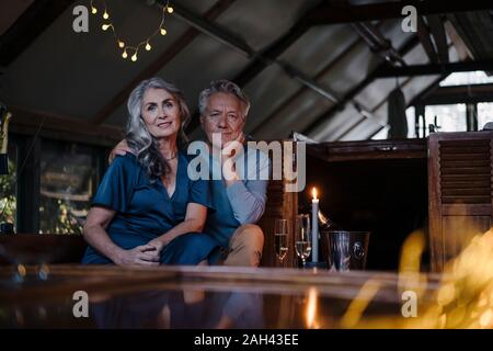 Portrait of senior couple having a candlelight dinner on a boat in boathouse Stock Photo