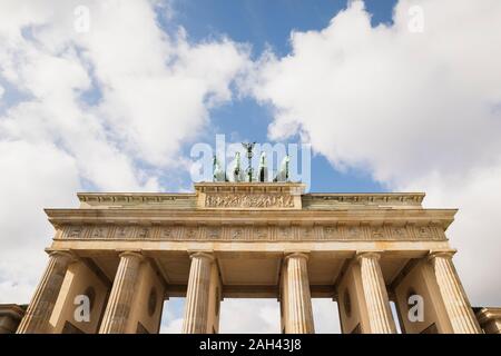 Germany, Berlin, Low angle view of Brandenburg Gate standing against clouds Stock Photo