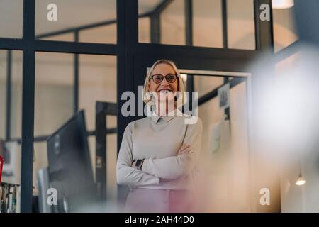 Portrait of smiling mature businesswoman in office
