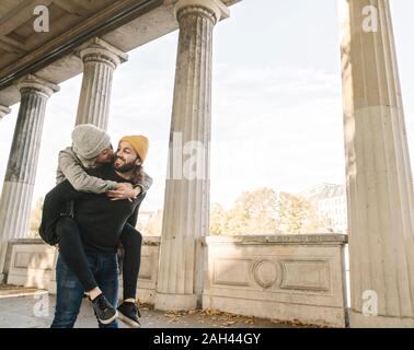 Happy young couple having fun in an arcade in the city, Berlin, Germany Stock Photo