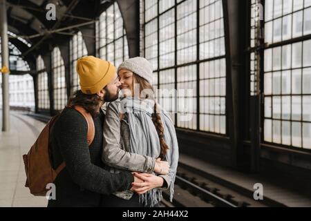 Young couple kissing at the station platform, Berlin, Germany