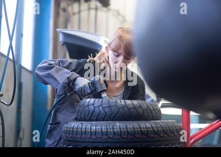 Female car mechanic working in repair garage Stock Photo