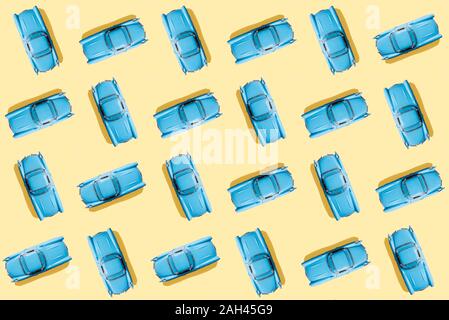 Vintage blue cars pattern on pastel yellow background Stock Photo
