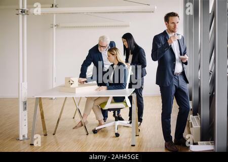 Businessman having a coffee break during a meeting in office Stock Photo