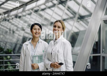 Portrait of two smiling female doctors Stock Photo