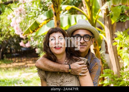 Portrait of mature couple, arm around Stock Photo