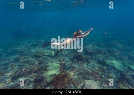 Young woman diving, Nusa Penida island, Bali, Indonesia Stock Photo