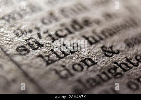 Word "suicide" printed on book page, close-up Stock Photo