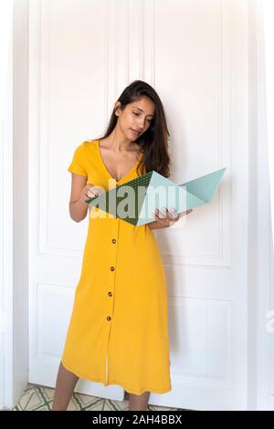Young woman looking in folder Stock Photo