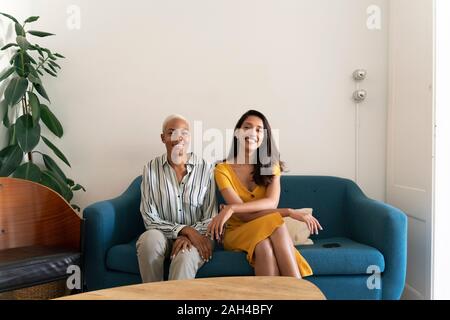 Portrait of two smiling women sitting on couch Stock Photo