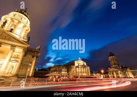 Germany, Berlin, Gendarmenmarkt, Mitte, German Cathedral, Konzerthaus and French Cathedral illuminated at dusk Stock Photo