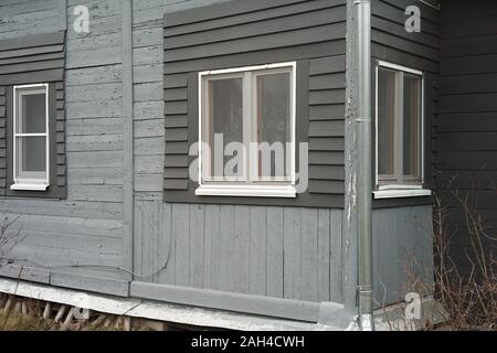 Old wooden house freshly painted in grey, outdoor cropped shot Stock Photo