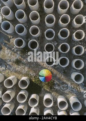 Aerial view of umbrella and concrete hoops Stock Photo