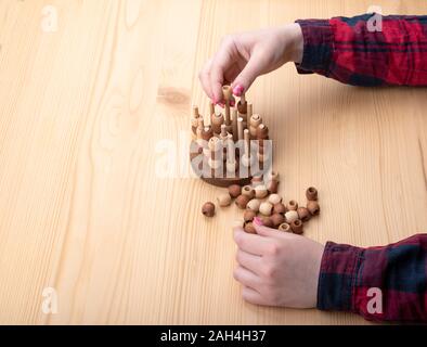 Girl plays tic tac toe. Bright manicure on nails. Board games concept. Copy space. Stock Photo