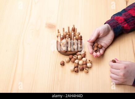 Girl plays tic tac toe. Bright manicure on nails. Board games concept. Copy space. Stock Photo