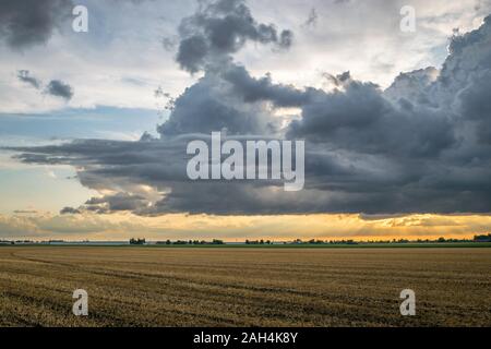 Dramatic storm clouds are forming over the wide open dutch landscape Stock Photo