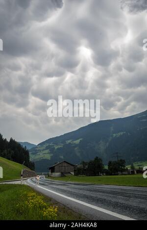 Thunderstorm with mammatus clouds over a valley in the Alps, Europe Stock Photo