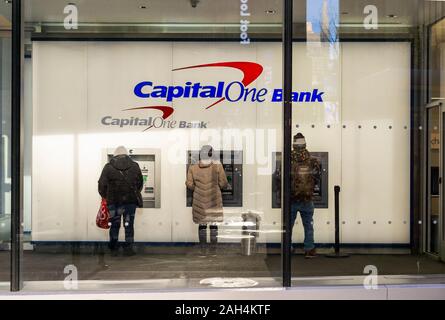 Customers use ATMs at a branch of Capital One Bank in Midtown Manhattan in New York on Friday, December 20, 2019.  (© Richard B. Levine) Stock Photo