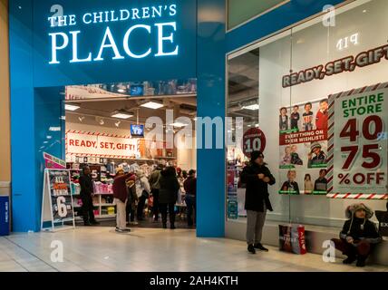 Crowds of last minute shoppers outside The ChildrenÕs Place at the Queens Center Mall in the borough of Queens in New York on so-called Super Saturday. the Saturday prior to Christmas, December 21, 2019. Retail analysts are predicting Super Saturday, which is also called Panic Saturday, sales to surpass Black Friday with over 147.8 million people shopping. (© Richard B. Levine) Stock Photo