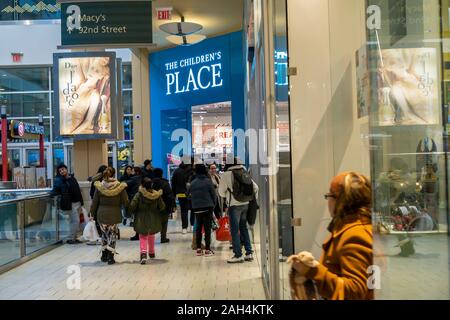 Crowds of last minute shoppers outside The ChildrenÕs Place at the Queens Center Mall in the borough of Queens in New York on so-called Super Saturday. the Saturday prior to Christmas, December 21, 2019. Retail analysts are predicting Super Saturday, which is also called Panic Saturday, sales to surpass Black Friday with over 147.8 million people shopping. (© Richard B. Levine) Stock Photo