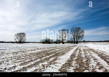 Plowed field covered with snow, winter in Nowiny, Poland Stock Photo