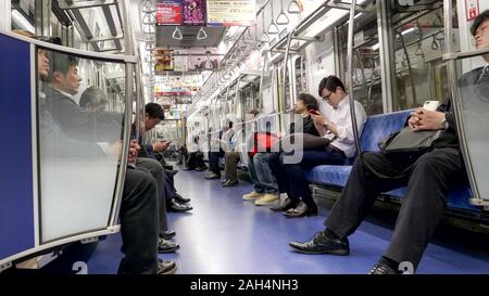 TOKYO, JAPAN - APRIL, 10, 2018: commuters in a subway car at tokyo Stock Photo