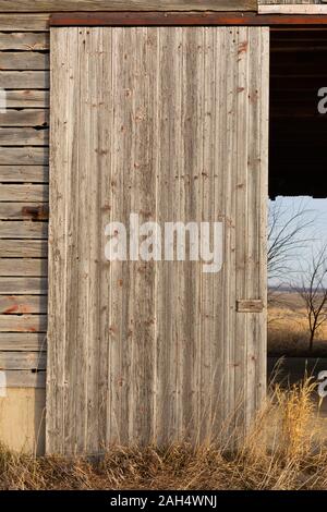 Old corn crib wooden doors on a sunny day.