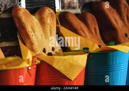Easter bunny cake in close up picture. Rustic buckets with homemade hot buns ready for Easter time. Easter bunnies bread baked as traditional holiday Stock Photo