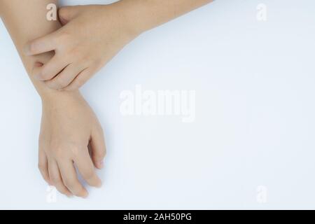 Close up woman scratching her itchy arm with allergy rash by hand on white background. Healthcare, skin problem and medical concept. Stock Photo