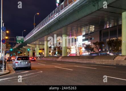 OSAKA, JAPAN - OCTOBER 14, 2019:  The night view of highway viaduct over the street in Osaka city. Osaka Stock Photo