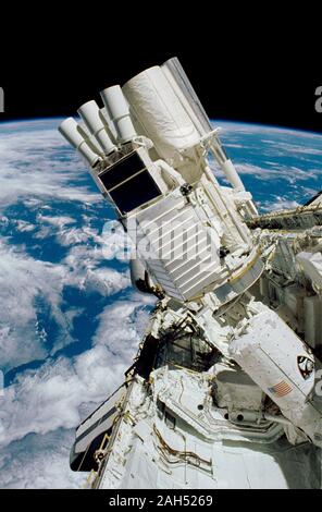 (2-10 Dec. 1990) --- The various components of the Astro-1 payload are seen backdropped against the blue and white Earth in this 35mm scene photographed through Columbia's aft flight deck windows. Parts of the Hopkins Ultraviolet Telescope (HUT), Ultraviolet Imaging Telescope (UIT) and the Wisconsin Ultraviolet Photo-Polarimeter Experiment (WUPPE) are visible on the Spacelab Pallet in the foreground. The Broad Band X-Ray Telescope (BBXRT) is behind this pallet and is not visible in this scene. The smaller cylinder in the foreground is the 'Igloo,' which is a pressurized container housing the C Stock Photo