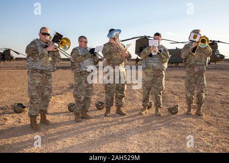 Eastern Syria, Syria. 23 December, 2019. The U.S. Army 1st Infantry Division band performs Christmas holiday classics for service members deployed in support of Operation Inherent Resolve combating the Islamic State December 23, 2019 in eastern Syria. Credit: Spc. Angel Ruszkiewicz/Planetpix/Alamy Live News Stock Photo