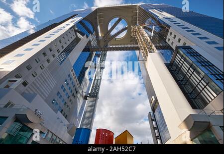 OSAKA, JAPAN - OCTOBER 15, 2019: The view from the ground up to the two towers of Umeda Sky Building (Kuchu Teien Observatory) connected with the Floa Stock Photo