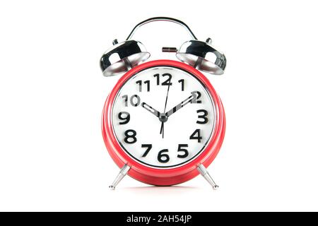 Vintage table clock with bell, red color, isolated on white bacground. Stock Photo